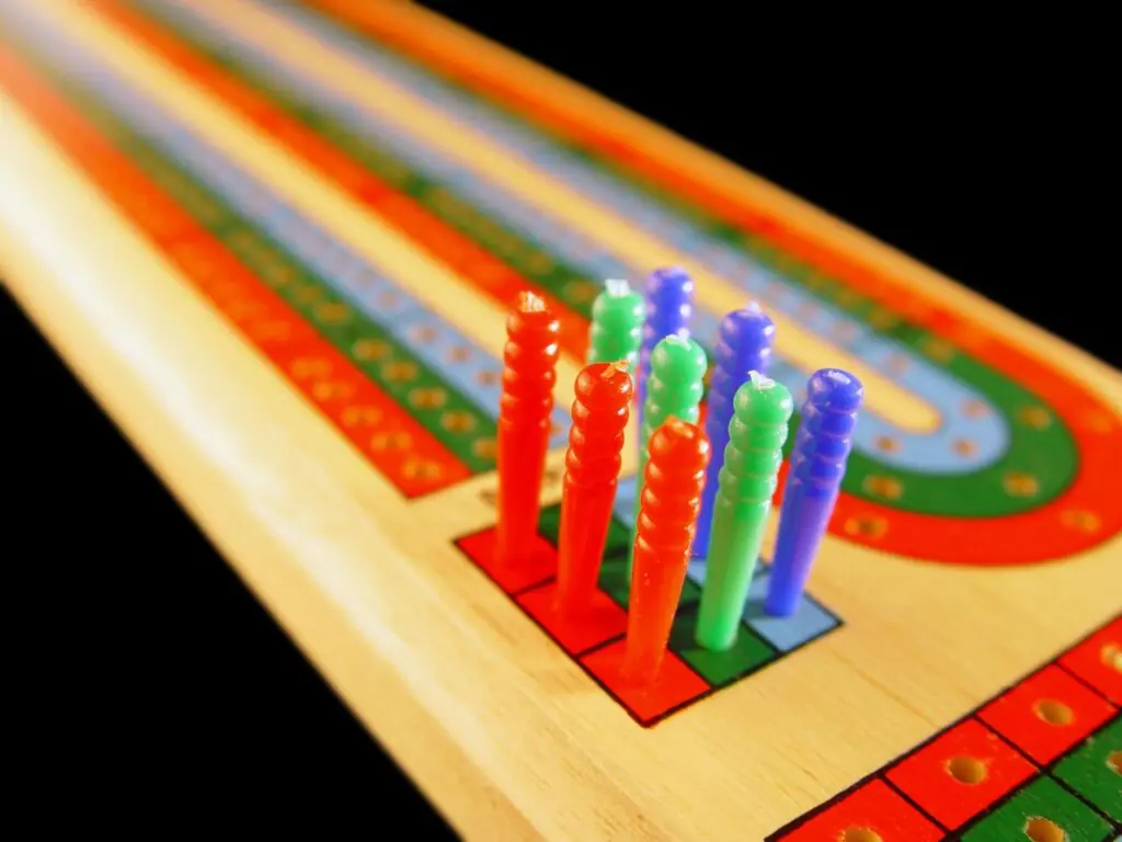 Cribbage board showing two parallel tracks with 121 holes per player